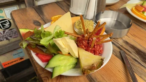 Vegan Appetizer Plate with Fresh Fruit, Salad, and Plant-Based Spread on Rustic 库存影片 341835394