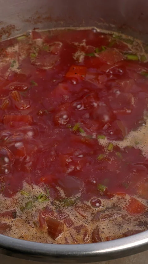 Vegan beet borscht bubbling in a pot.  Vertical video. Stock Footage 296285561