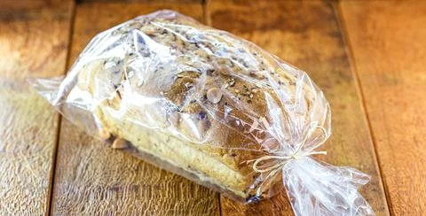 Vegan bread made with grains packed in plastic bag, handmade product for sale Stock Photos