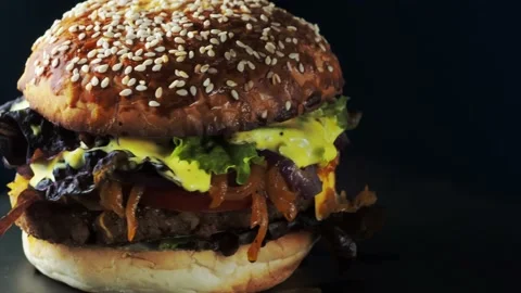 Vegan burger revolves on a slate plate. Stock Footage 197548830