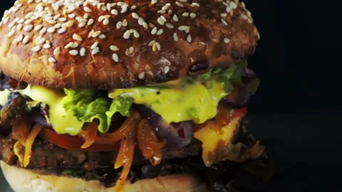 Vegan burger revolves on a slate plate. Stock Footage 197548901
