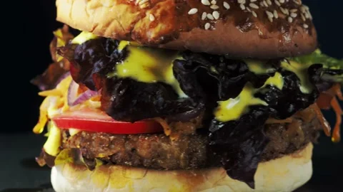 Vegan burger revolves on a slate plate. Video stock 197549037
