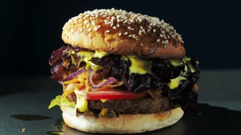 Vegan burger revolves on a slate plate. Video stock 197549076