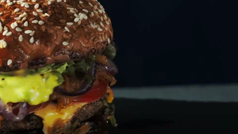 Vegan burger revolves on a slate plate. 動画素材 197549091