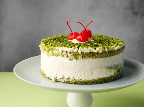 Vegan cake with spinach and cherry on gray background. Concept of healthy eat Foto stock