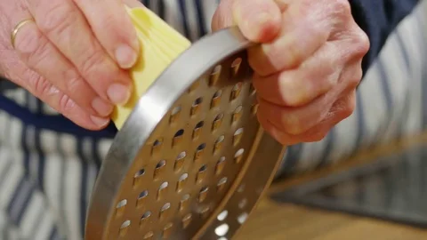 Vegan cheese being shredded using a grater Stock Footage 84554731