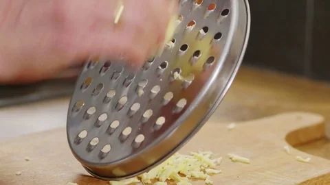 Vegan cheese being shredded using a grater Stock Footage 84554741