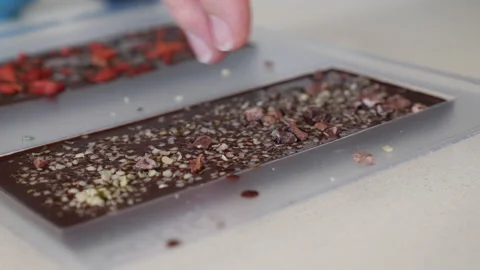 Vegan chocolate making, adding coco nibs. Stock-Footage 137155718