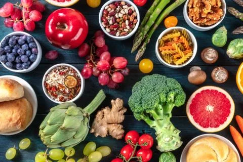 Vegan food variety. Fruit and vegetables, legumes, nuts, mushrooms, rice, pasta Stock Photos