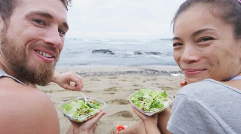 Vegan friends eating vegetarian salad lunch meal - people in healthy lifestyle Stock Footage