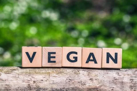 Vegan label on a tree log Stock Photos