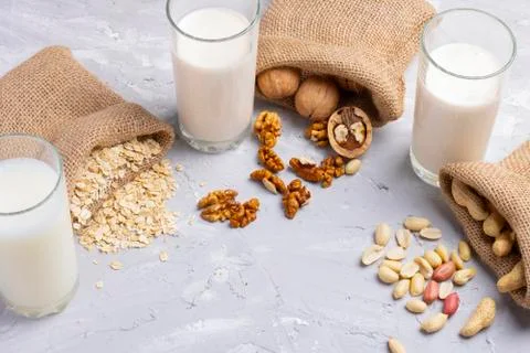 Vegan nut milk on a table. Hazelnut, walnut and almond milk. Healthy breakfas Stock Photos