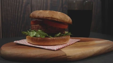 Vegan plant based burger served on rustic cutting board with soda Stock Footage 111224896