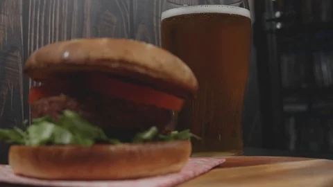 Vegan plant based burger served on rustic cutting board with beer Stock Footage 111224934