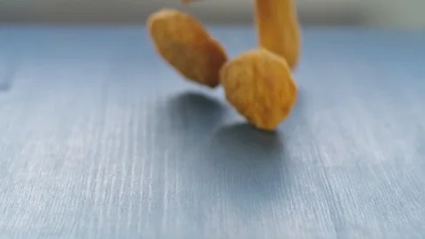 Vegan plant based nuggets falling on table in slow motion 스톡 동영상 115794520