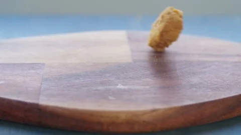 Vegan plant based nuggets falling on cutting board in slow motion Stock Footage 115794625