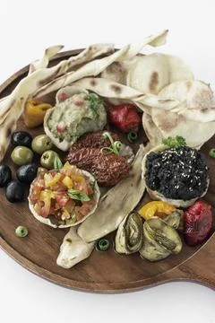 Vegan tapas snacks sharing platter board on white background Stock Photos