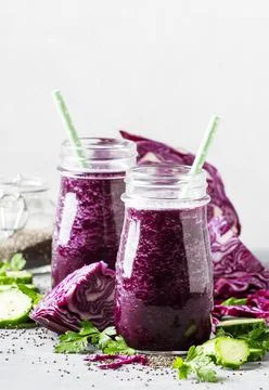 Vegan vegetable smoothie with purple cabbage, cucumber and chia seeds in glas Stock Photos