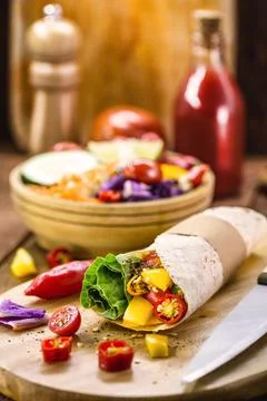 Vegan wrap, made with flat bread and various vegetables, healthy fast food Stock Photos