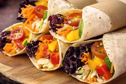 Vegan wrap, made with flat bread and various vegetables, healthy fast food Stock Photos