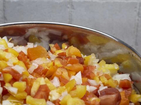 A vegatable close-up with copy space of fresh salsa including red pepper, yel Stock Photos