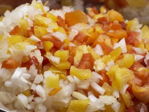 A vegatable close-up of fresh salsa including red pepper, yellow pepper, oran Stock Photos