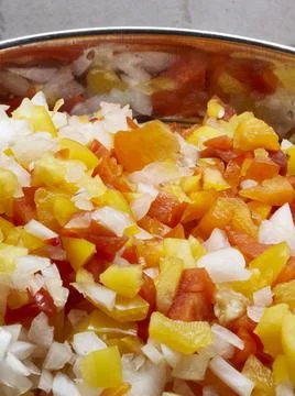 A vegatable close-up of fresh salsa including red pepper, yellow pepper, oran Stock Photos