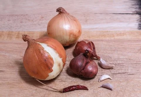 Vegetable and herb on chopping block Stock Photos