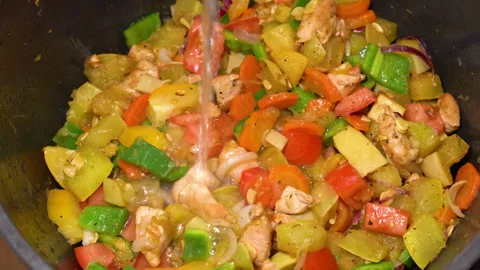 Vegetable and meat stew fried in a pan, water is added. High quality 4k footage Stock Footage 248435066