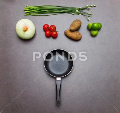 Vegetable and the pan background for cooking. Stock Photos