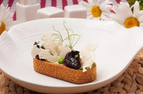 Vegetable appetizer made of shortbread, cabbage, green peas and beets Stock Photos