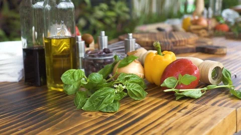 Vegetable background on wooden kitchen table close up. Fresh vegetable, basil Video stock 98445278