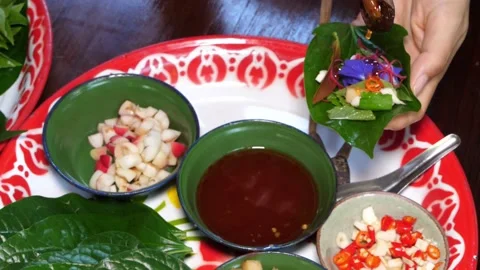 Vegetable in betel leaf pack to make a royal leaf wrap appetizer or Miang kham Stock Footage 237071796