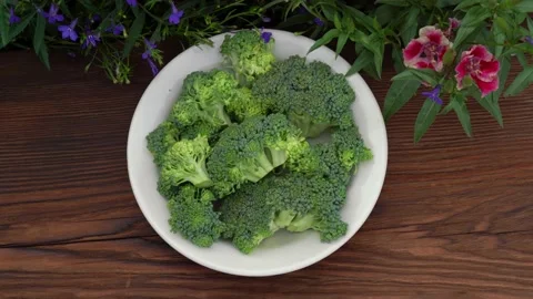 Vegetable broccoli in a white plate on a dark wooden background framed with Stock Footage 142729026