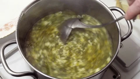 Vegetable broth and egg stracciatella in preparation for the Easter lunch Video stock 152292311
