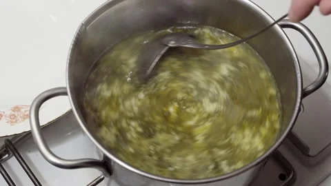 Vegetable broth and egg stracciatella in preparation for the Easter lunch Stock Footage 152292316