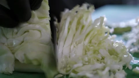 Vegetable chef hands in gloves cutting cabbage thin and fast on kitchen table Stock-Footage 135218998