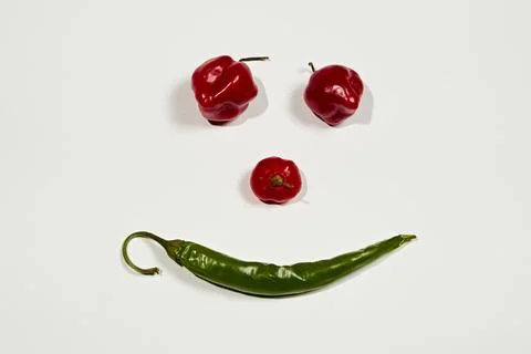 Vegetable chilli, chile face on white backgroung Stock Photos