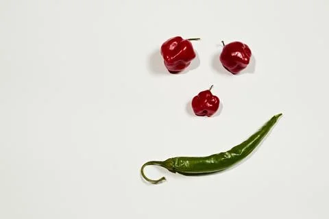 Vegetable chilli, chile face on white backgroung Stock Photos