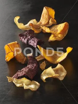 Vegetable Chips On A Black Surface