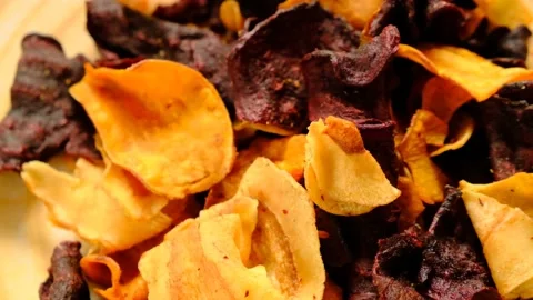 Vegetable chips.Rotation. Crispy beetroot, celery and Jerusalem artichoke chips Stock Footage 157114144