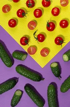 Vegetable colorful abstract pattern - ripe cherry tomato, green young cucumbe Stock Photos