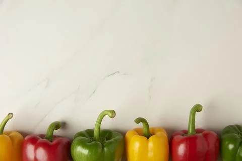Vegetable concept several of red, yellow, and red bell peppers being organize Foto stock