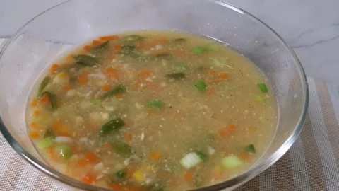 Vegetable Corn Soup with Carrots and Beans in a Glass Bowl Stock Footage 236774474