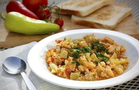 Vegetable dish called lecho containing peppers, tomatoes, onion, eggs and tofu Stock Photos