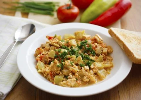 Vegetable dish called lecho containing peppers, tomatoes, onion, eggs, tofu Stock Photos