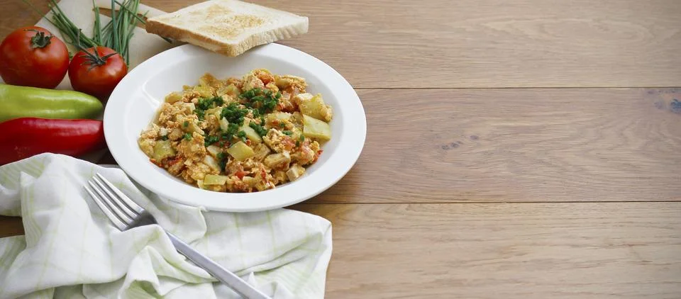 Vegetable dish called lecho containing peppers, tomatoes, onion, eggs, tomatoes Stock Photos