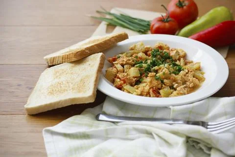 Vegetable dish called lecho containing peppers, tomatoes, onion, eggs, tomatoes Stock Photos