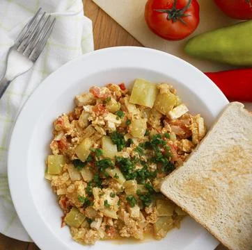Vegetable dish called lecho containing peppers, tomatoes, onion, eggs and tofu Stock Photos