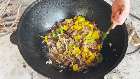 The vegetable dish with meat is stirred with the flat ladle Stock Footage 243265664